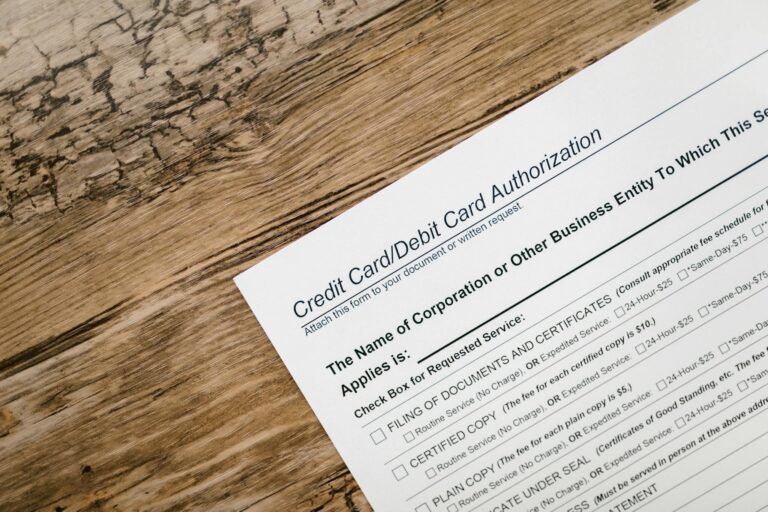 A credit card authorization form placed on a wooden desk, highlighting business paperwork essentials.